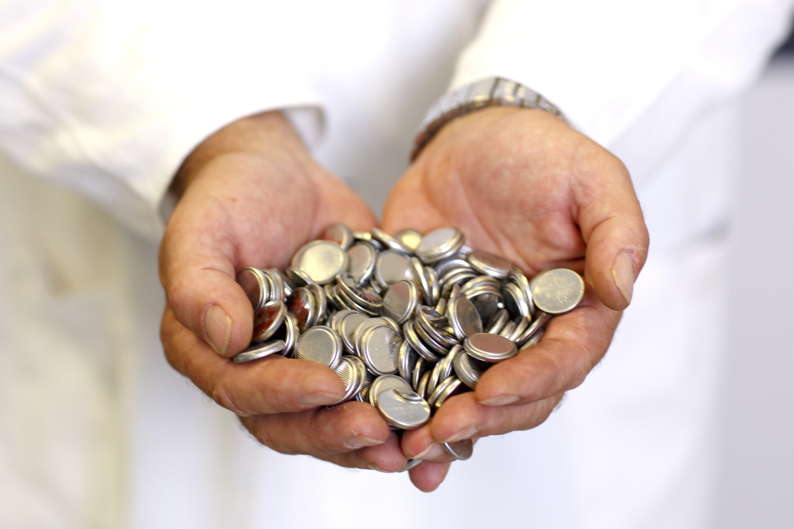 Bunch of coins in persons hands