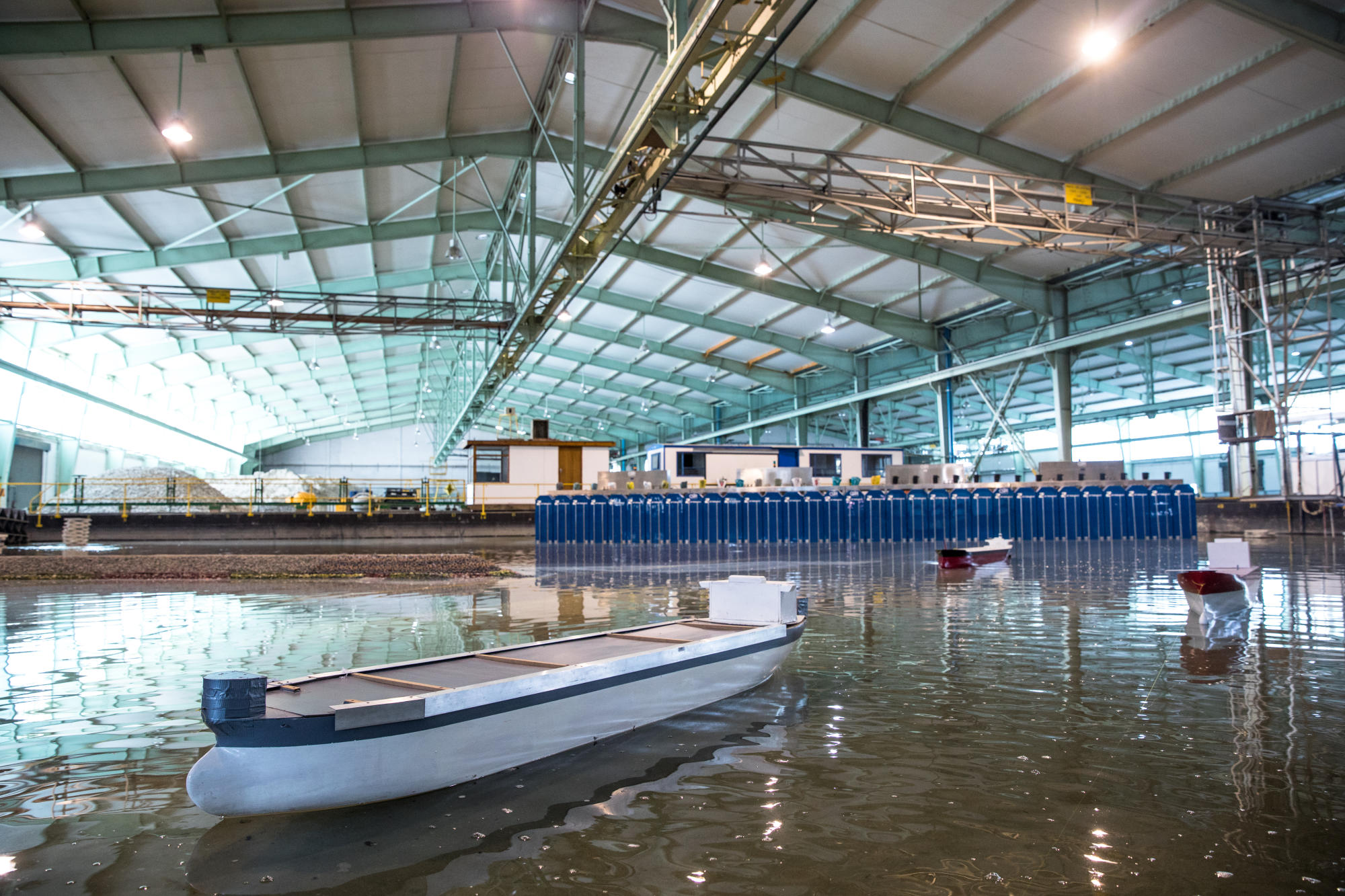 Hand holding a container with yellowish liquid