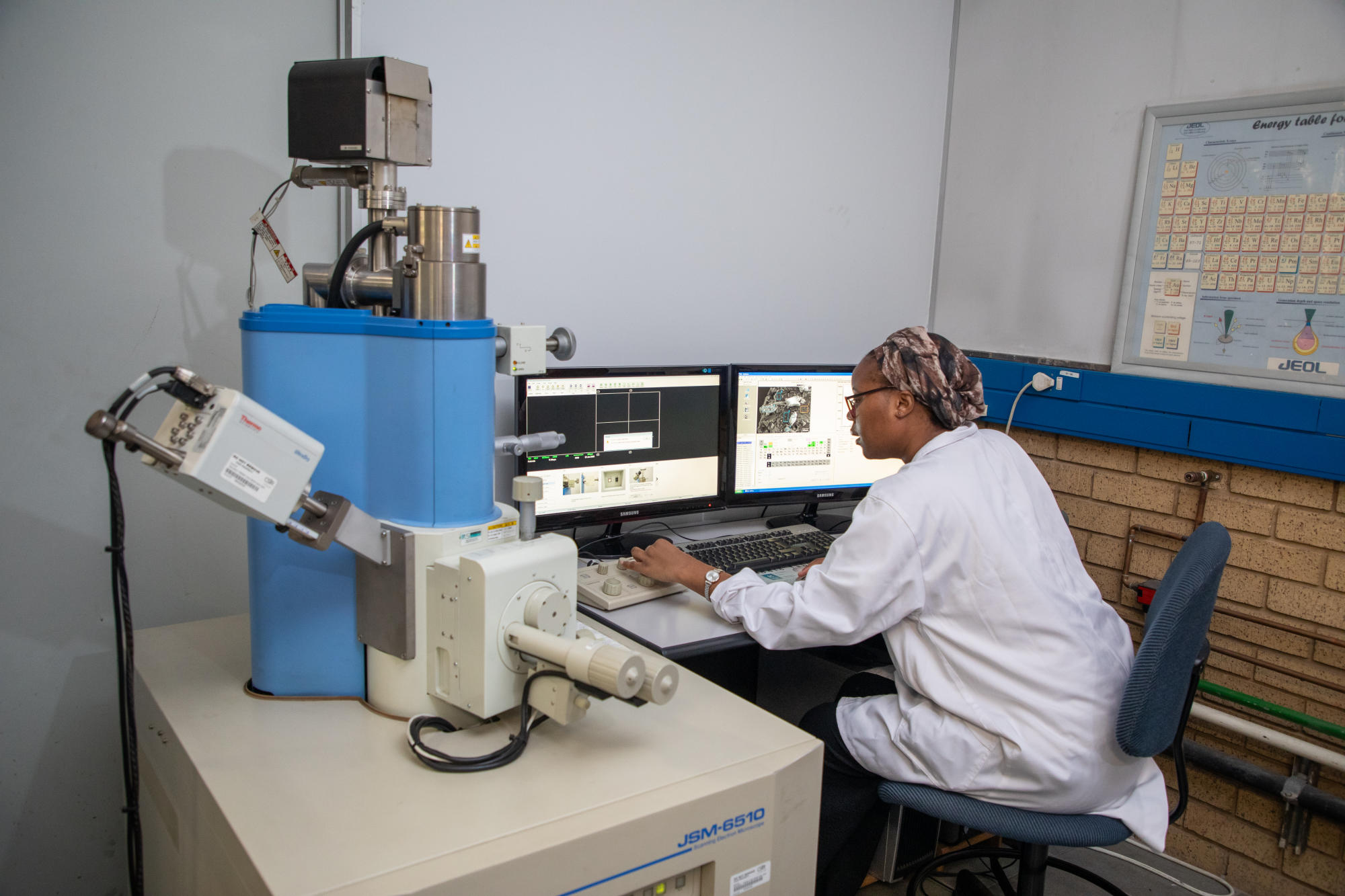 Hand holding a container with yellowish liquid