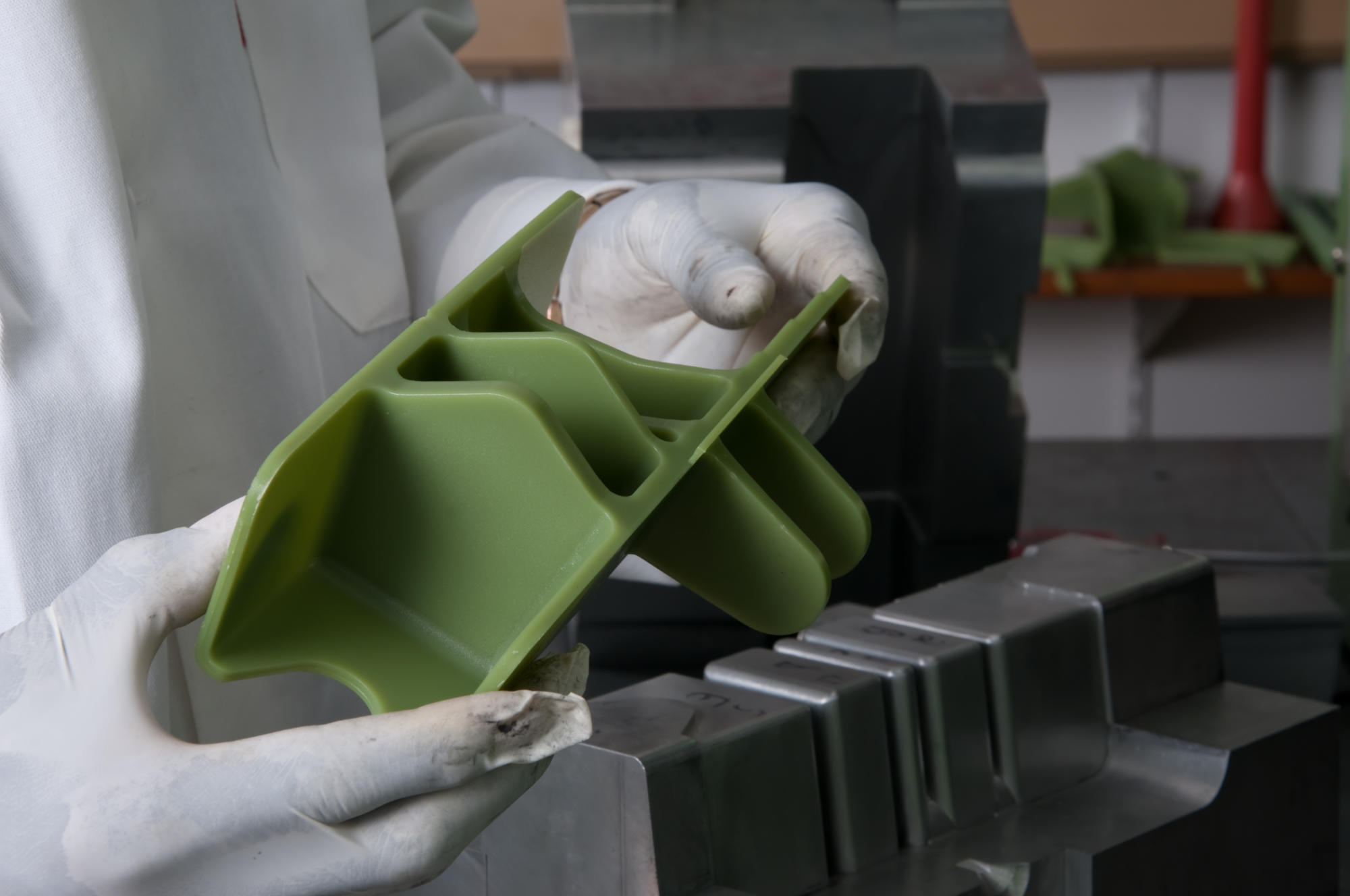 Hand holding a container with yellowish liquid