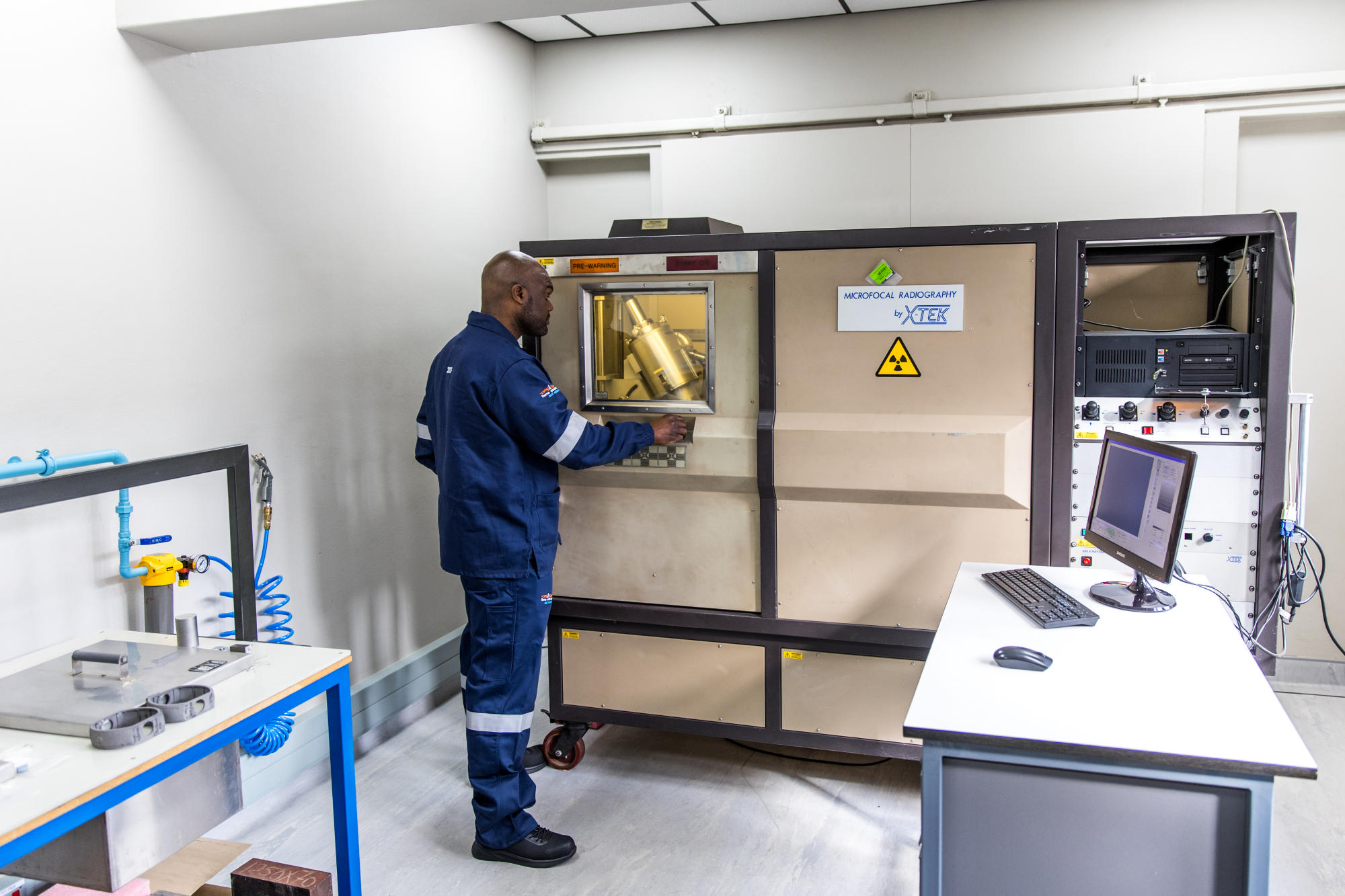 Hand holding a container with yellowish liquid