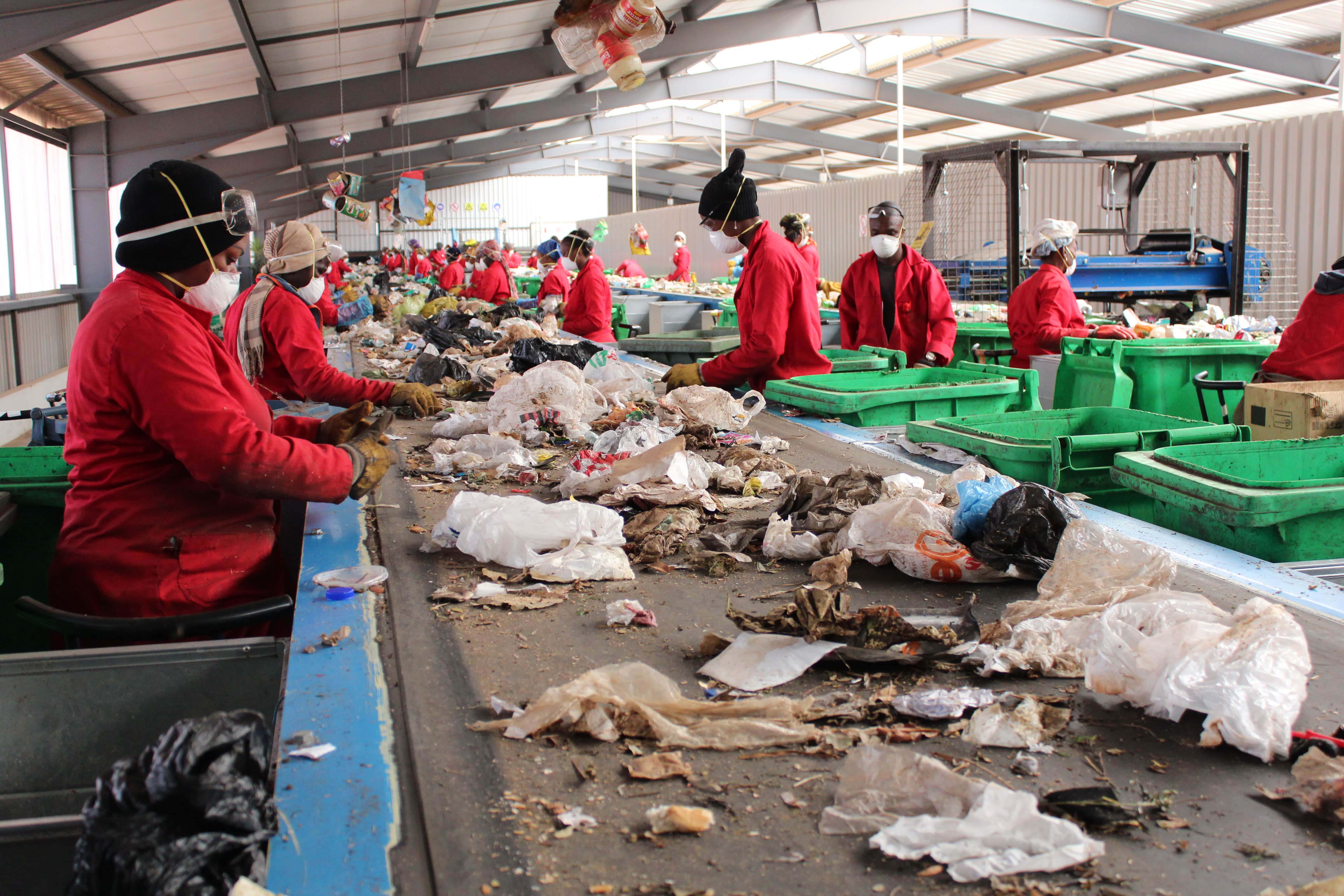 Peoplee sifting through plastic items
