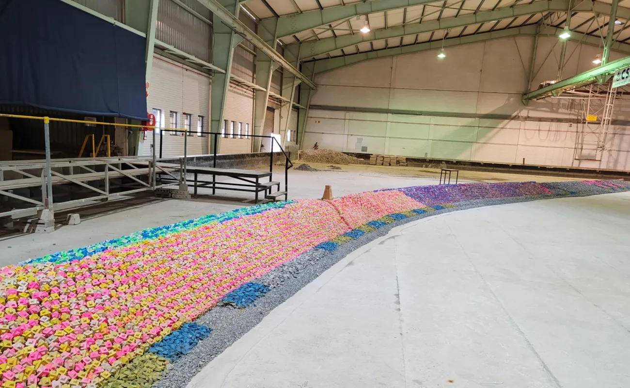 Hand holding a container with yellowish liquid