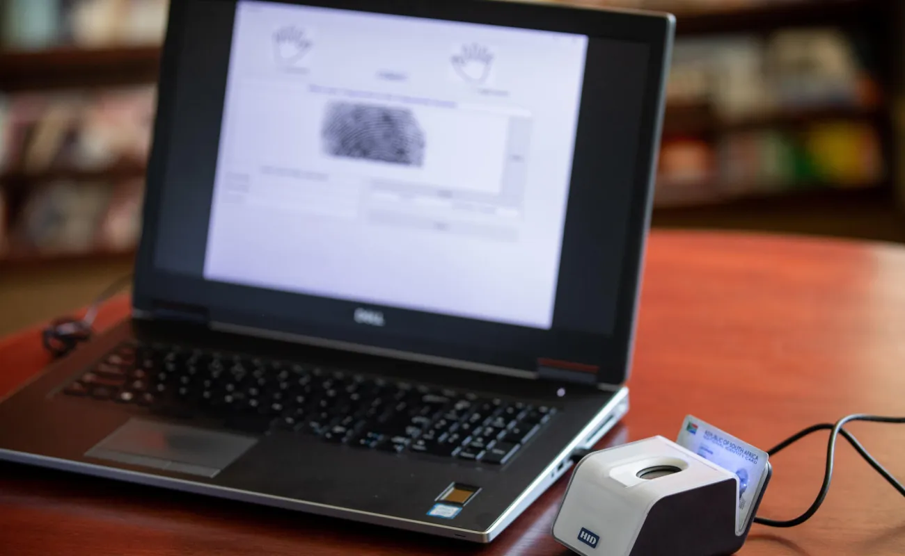Hand holding a container with yellowish liquid