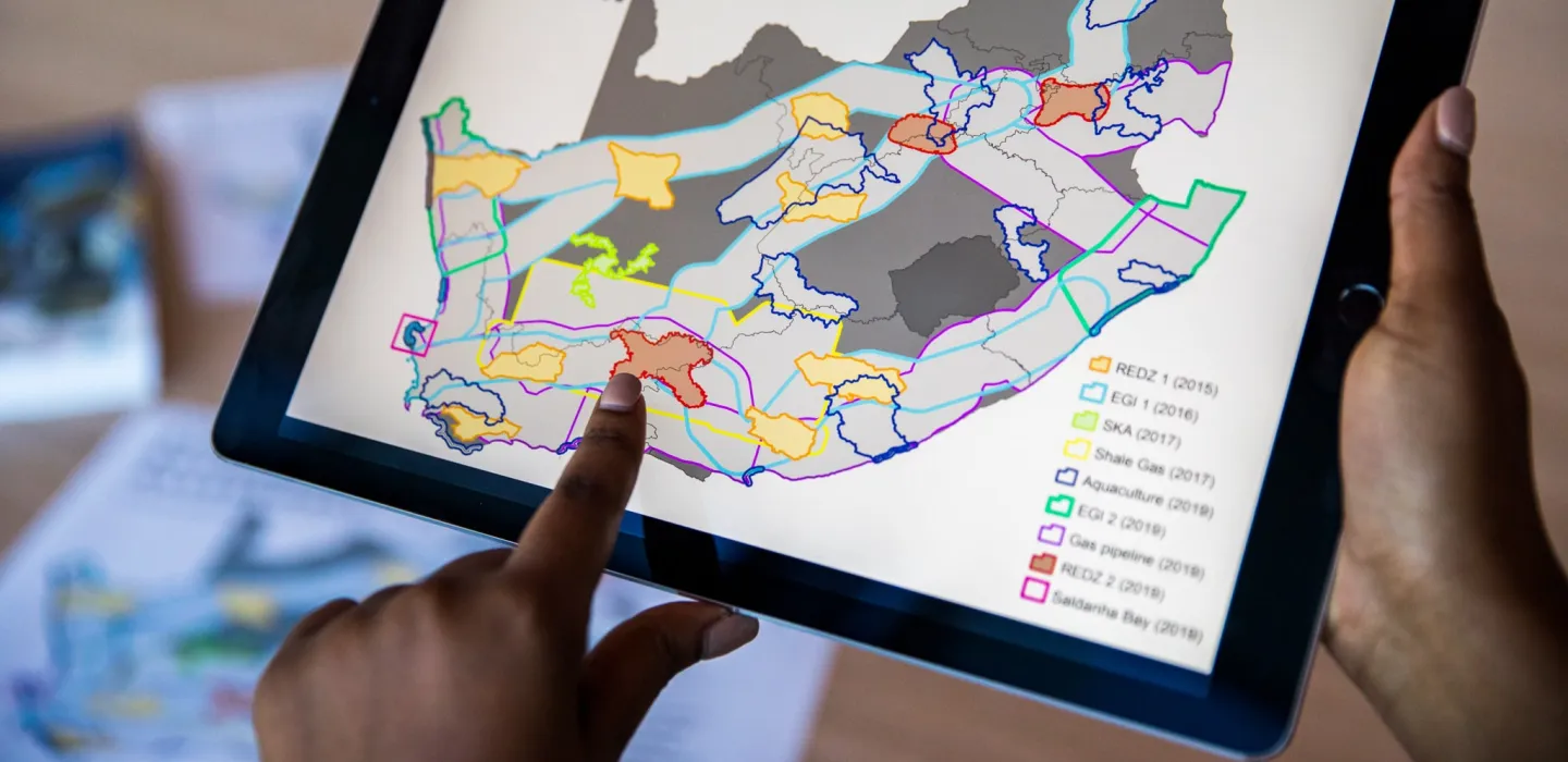 Finger pointing at iPad screen