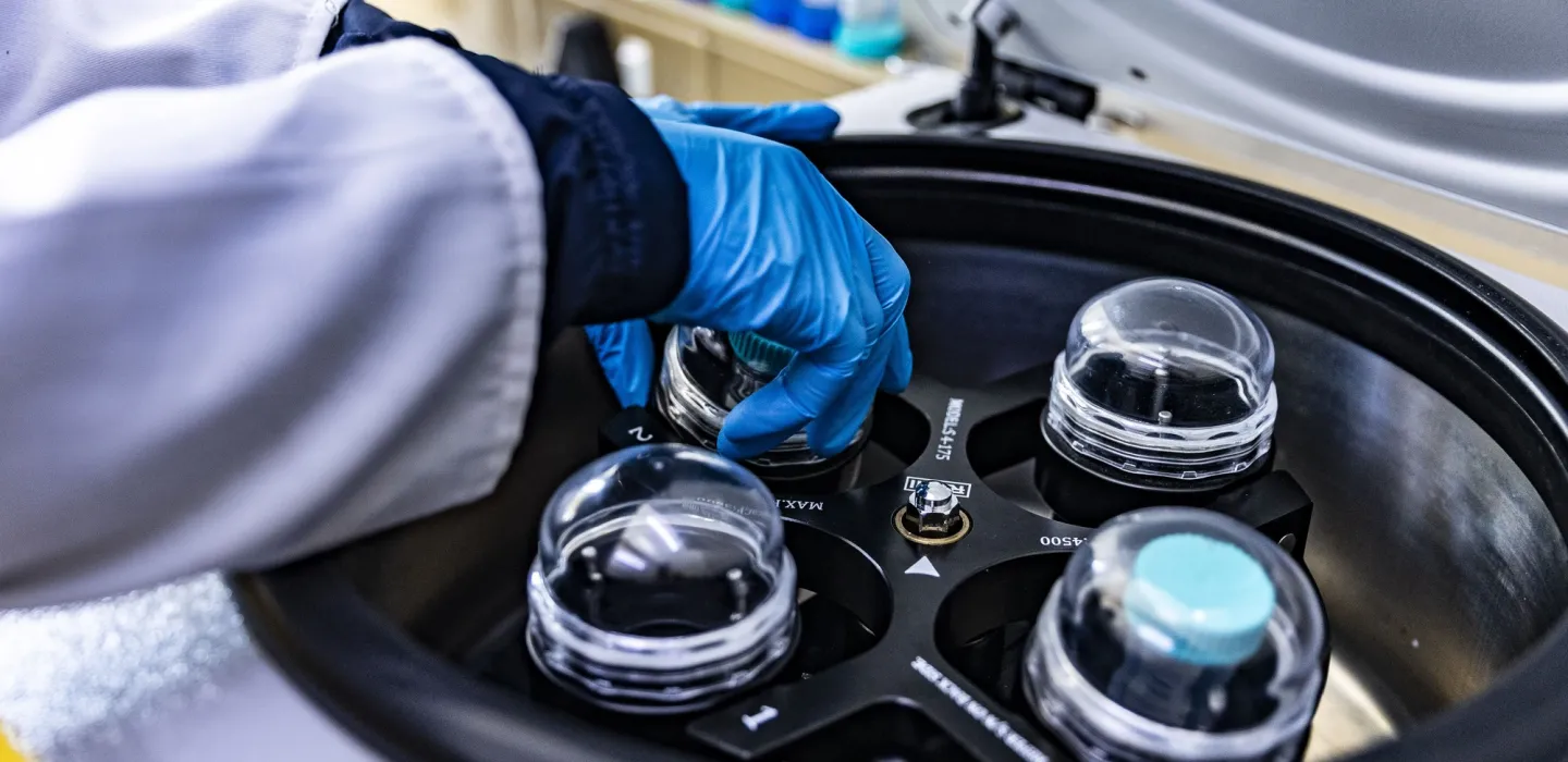 Scientist placing items in container
