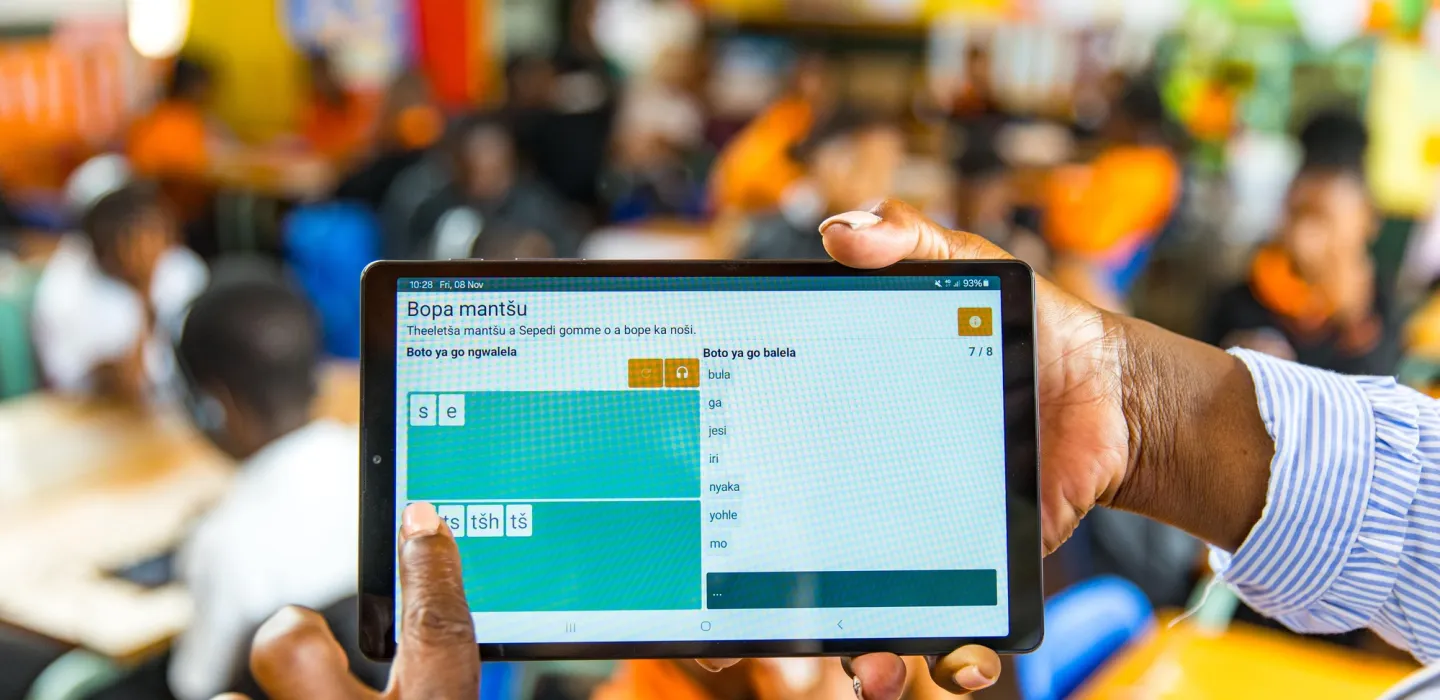 Finger pointing at iPad screen