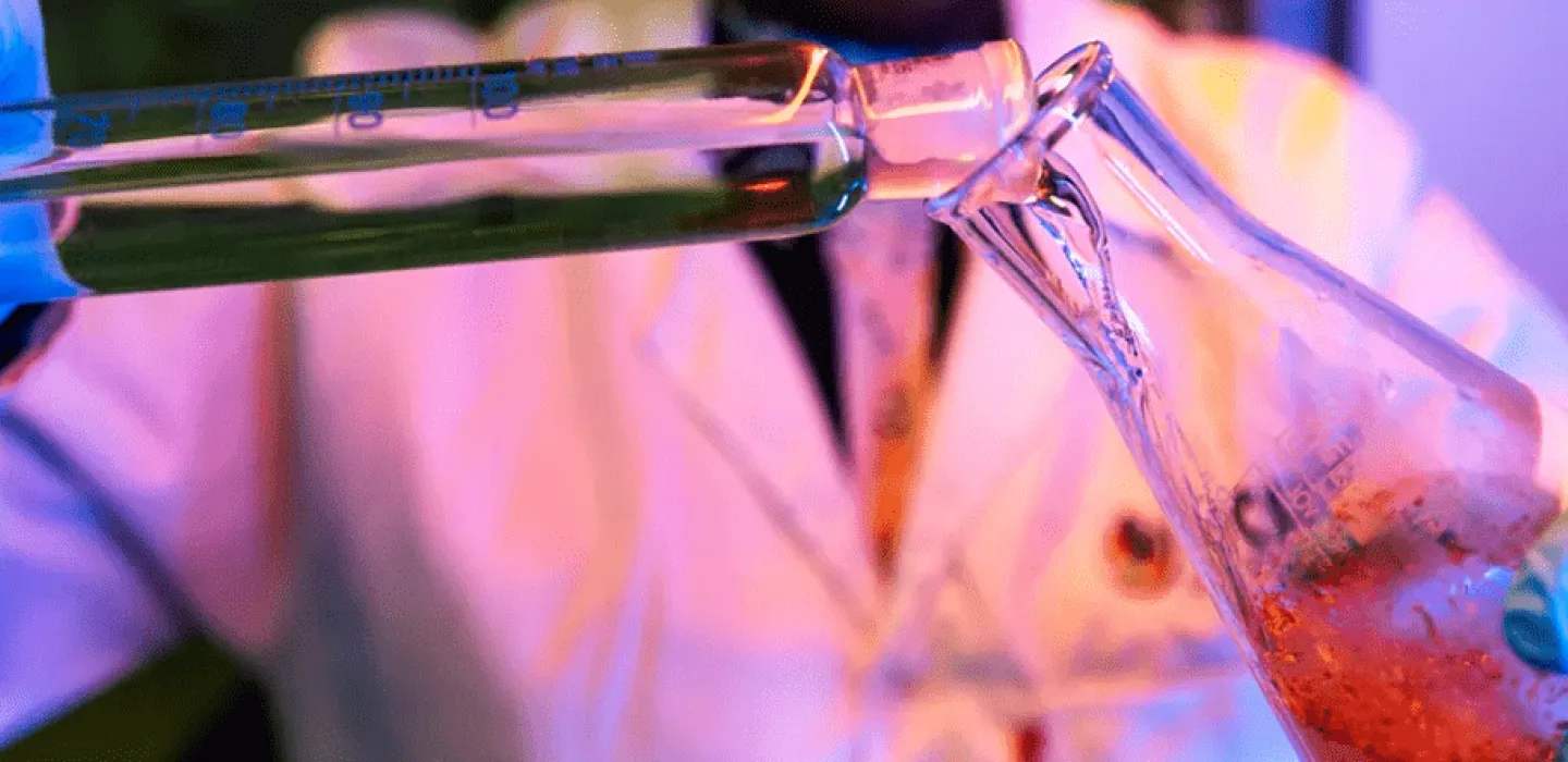 Liquid being poured into a glass beaker