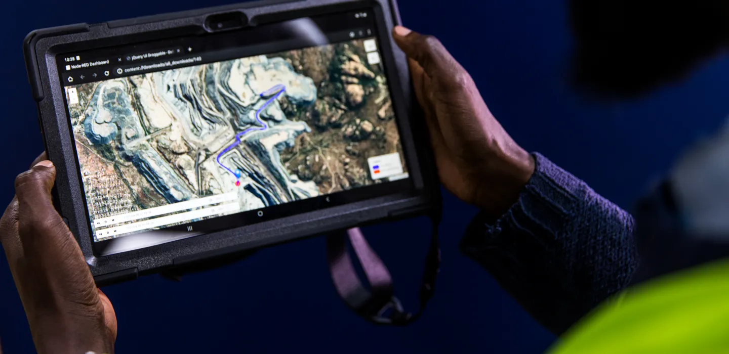 man looking at industrial site on ipad